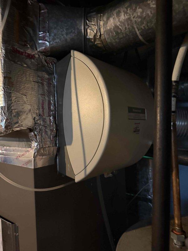 Performed complimentary second opinion evaluation on residential HVAC system following recommendation from another contractor for complete system replacement. Customer reported air conditioning unit operational but unable to maintain desired temperature during peak cooling demand days. Conducted comprehensive system assessment including temperature differential measurements across evaporator coil, which registered 55.5°F supply air temperature. Inspected ductwork installation in attic space, noting reflective insulation wrapping and overall duct condition. Evaluated furnace installation completed three years prior, as concerns were raised by previous contractor regarding equipment performance. Examined humidifier integration, copper refrigerant lines, and flexible duct connections in mechanical room. Documented system components and operating conditions through photographic evidence for reference. Provided professional assessment findings to customer regarding actual system condition v