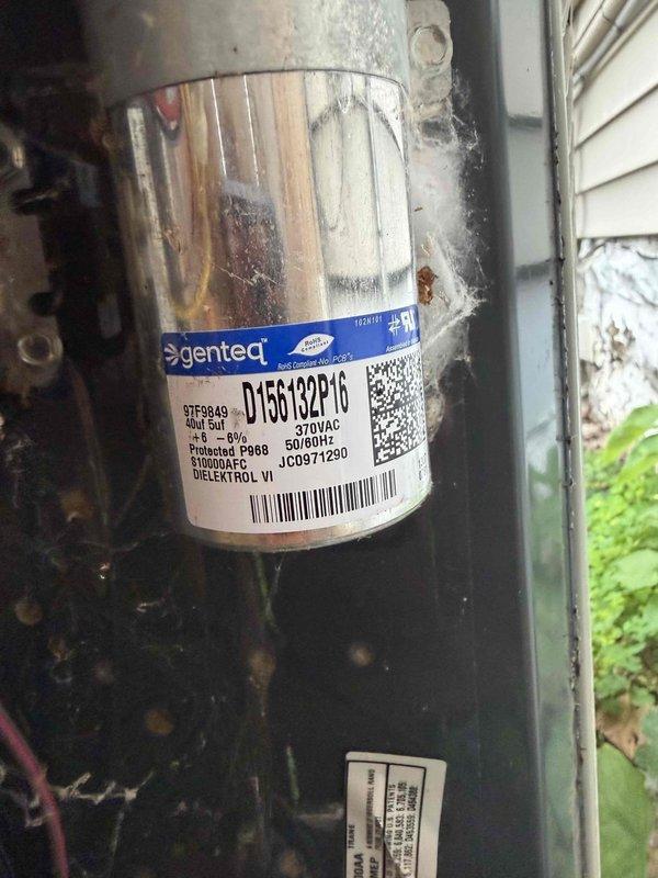 Performed diagnostic evaluation on two aging HVAC systems for new homeowner following recent storm damage. Inspected non-operational outdoor unit, identifying Genteq compressor model D15G132P16 rated for 460VAC operation. Documented compressor specifications, electrical ratings, and overall condition of outdoor condensing unit including cabinet integrity and component connections. Evaluated indoor air handler assembly, inspecting evaporator coil cleanliness, condensate drain line configuration with multiple PVC routing sections, and flexible ductwork connections. Assessed insulation wrapping on refrigerant lines and documented system component conditions through photographic records. Both units confirmed as 10+ years old requiring comprehensive inspection to determine operational status and repair feasibility following storm-related service interruption.