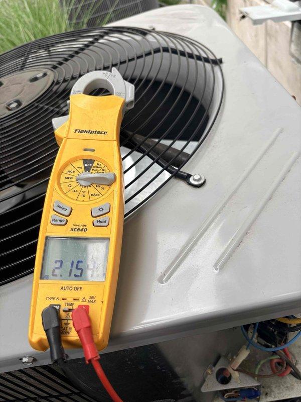 Responded to no cooling complaint on main level system. Performed diagnostic evaluation of outdoor condensing unit. Measured compressor amperage at 2.15 amps using clamp meter and inspected dual-run capacitor rated at 60/5 MFD 370V along with contactor assembly, verifying electrical connections and component operation to identify cause of insufficient cooling performance.