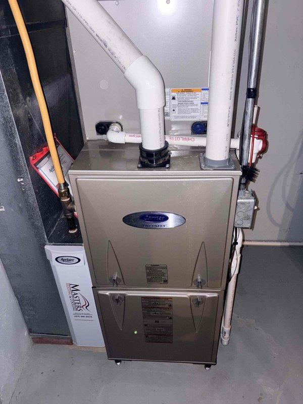 Completed first cooling maintenance service on residential HVAC system. Performed comprehensive inspection of furnace unit and AprilAire air filtration system, verified thermostat operation showing proper temperature control at 70°F, and inspected all PVC condensate drainage lines and connections for proper operation.