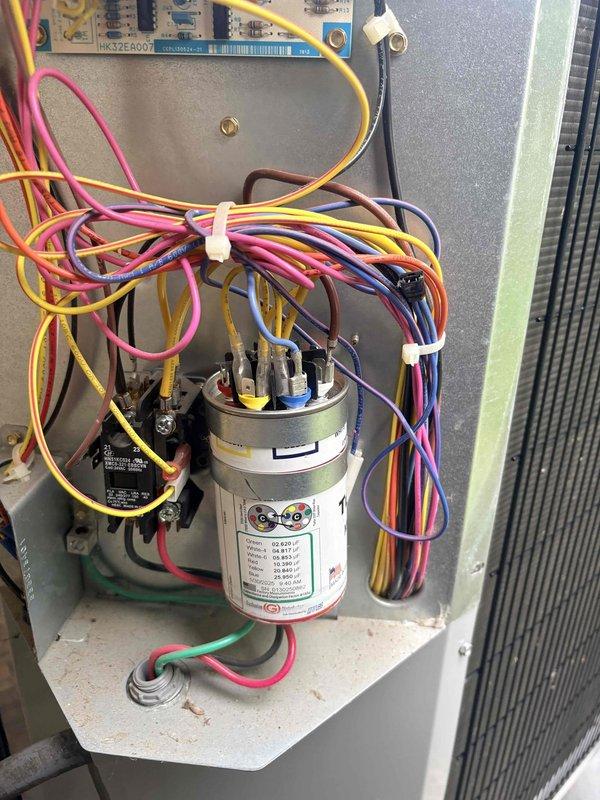 Responded to no cooling complaint with outdoor fan running but no cold air production. Performed diagnostic testing on condensing unit electrical components using clamp meter, measuring capacitor microfarad ratings at 0.15 MFD, indicating failed dual run capacitor well below manufacturer specifications. Replaced defective capacitor, verified proper compressor amperage draw, and confirmed system returned to normal cooling operation with appropriate temperature split across evaporator coil.