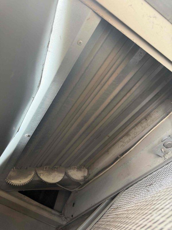 Responded to callback for inadequate cooling with indoor temperature reaching 83 degrees by afternoon. Upon inspection, found evaporator coil with moderate dust and debris accumulation affecting heat transfer efficiency. Took diagnostic measurements using digital multimeter, recording readings of system components and refrigerant pressures at outdoor condensing unit. Documented condition of copper refrigerant lines, brass fittings, and compressor connections showing normal wear and oxidation. Assessed airflow restriction caused by soiled coil surfaces and filter contamination, which was contributing to reduced cooling capacity and afternoon temperature rise.