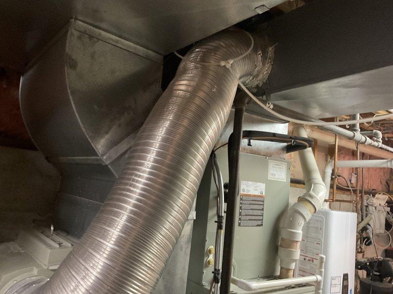 Conducted comprehensive site evaluation of existing dual-zone HVAC system for replacement estimate. Assessed two outdoor condenser units positioned on concrete pads and indoor air handling equipment including furnace and ductwork in basement mechanical room. Documented current system configuration, equipment condition, and installation requirements to provide complete replacement options for both operating systems.