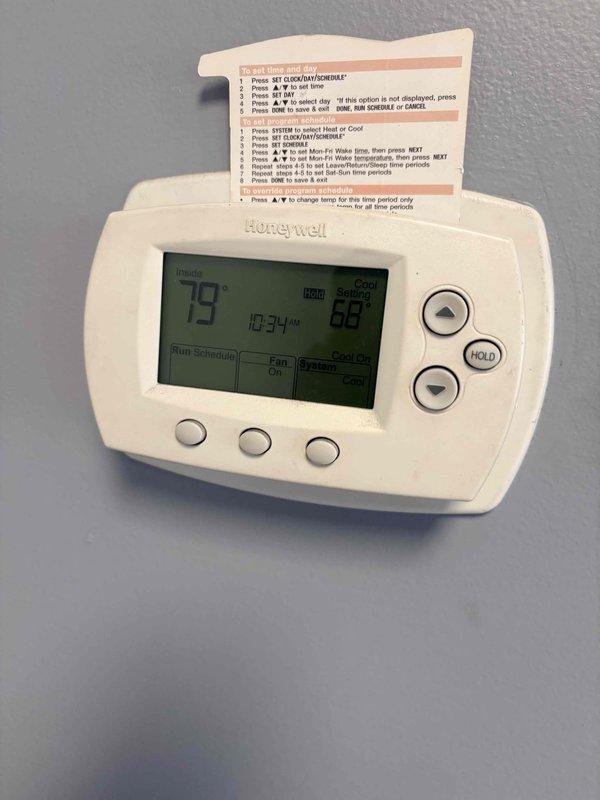 Responded to no cooling complaint at commercial building. Upon arrival, checked Honeywell programmable thermostat which displayed 79°F ambient temperature with setpoint at 68°F and system indicating "Cool On" mode. Performed diagnostic testing and measured supply air temperature at 32.9°F, confirming system is producing proper cooling output and compressor is functioning correctly. Issue determined to be thermostat configuration or airflow distribution rather than blower motor failure as initially suspected.