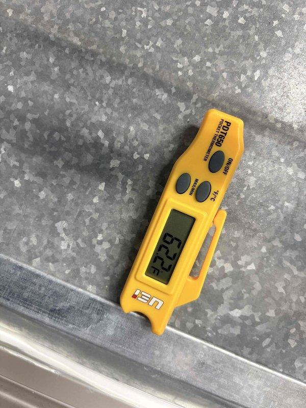 Responded to no cooling complaint at commercial building. Upon arrival, checked Honeywell programmable thermostat which displayed 79°F ambient temperature with setpoint at 68°F and system indicating "Cool On" mode. Performed diagnostic testing and measured supply air temperature at 32.9°F, confirming system is producing proper cooling output and compressor is functioning correctly. Issue determined to be thermostat configuration or airflow distribution rather than blower motor failure as initially suspected.
