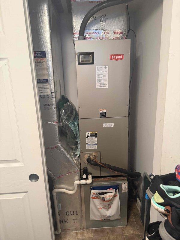 # A/C Diagnostic – Water Leak

Responded to service call for air conditioning system experiencing water leakage on floor while unit continued to operate. Upon arrival, inspected Bryant air handler unit located in utility closet. Examined condensate drainage system including white PVC drain lines running from air handler. Checked for proper drain line pitch, clogs, and blockages in primary and secondary drain pans. Inspected condensate pump operation if applicable. Verified drain line termination point and cleared any obstructions preventing proper water discharge. Tested system operation to confirm condensate was draining properly through primary drain line without overflow. Ensured secondary drain pan was clear and functional as backup safety measure. System tested and operating normally with no further water accumulation observed on floor.