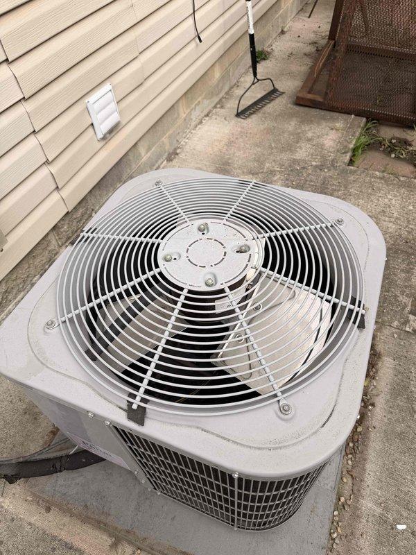 Completed comprehensive air conditioning tune-up on outdoor condenser unit. Performed full system inspection including condenser coil examination, verified proper airflow through protective grille, checked electrical connections at disconnect box, and confirmed unit operation. System found to be in functional condition with normal outdoor weathering; all components operating within manufacturer specifications.