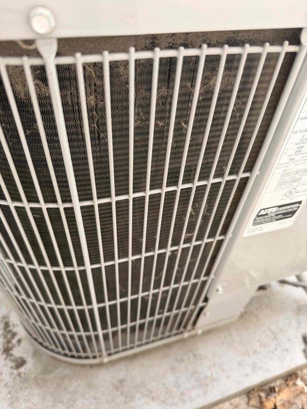 Completed comprehensive air conditioning tune-up on outdoor condenser unit. Performed full system inspection including condenser coil examination, verified proper airflow through protective grille, checked electrical connections at disconnect box, and confirmed unit operation. System found to be in functional condition with normal outdoor weathering; all components operating within manufacturer specifications.