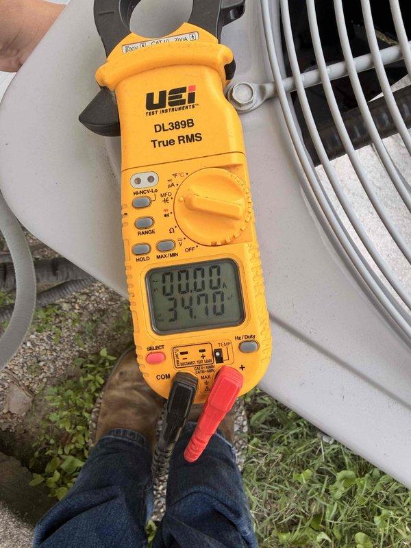 Performed comprehensive air conditioning tune-up on residential outdoor condensing unit. Conducted electrical diagnostics using digital clamp meter, recording amperage readings to verify compressor and fan motor performance within manufacturer specifications. Inspected condenser coil fins and exterior housing, noting minor dirt accumulation and weathering consistent with normal outdoor exposure.