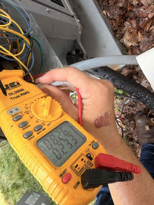 Completed scheduled cooling maintenance on outdoor air conditioning unit. Performed electrical diagnostics using digital multimeter to verify proper voltage and amperage at control panel. Inspected condenser coil and noted moderate debris accumulation on heat exchanger fins with visible dirt buildup and minor surface oxidation requiring attention for optimal heat transfer efficiency.