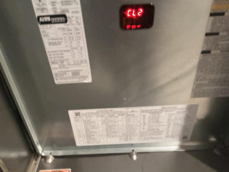 Completed full HVAC system installation in residential utility room, including Carrier furnace and air handler assembly. Installed gray metal furnace cabinet with integrated digital LED display and control panel, mounted metallic air handler unit above furnace, and established all electrical connections with proper color-coded control wiring. Routed and secured flexible ductwork from air handler, installed white PVC condensate drainage and venting piping per manufacturer specifications for high-efficiency system operation. Verified all manufacturer labels and specification plates properly affixed to equipment, confirmed digital display functionality, and ensured all utility connections properly secured and operational.