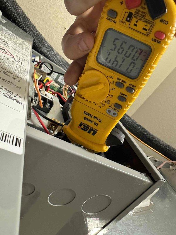 Completed comprehensive cooling maintenance inspection on HVAC system. Identified and documented heavily soiled air filter with significant dust and debris accumulation requiring replacement to restore proper airflow and system efficiency. Performed electrical diagnostics using digital multimeter, recording voltage readings at main electrical panel to verify proper power supply and system operation.