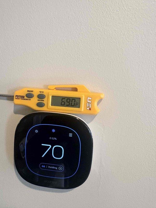 Responded to no cooling complaint on residential air conditioning system. Upon arrival, measured supply air temperature at 50.5°F and return air temperature at 69°F, confirming adequate cooling operation with approximately 18.5°F temperature differential. Thermostat displayed 70°F setpoint with current indoor temperature at 66°F in hold mode. System found operating within normal parameters with no mechanical deficiencies identified.