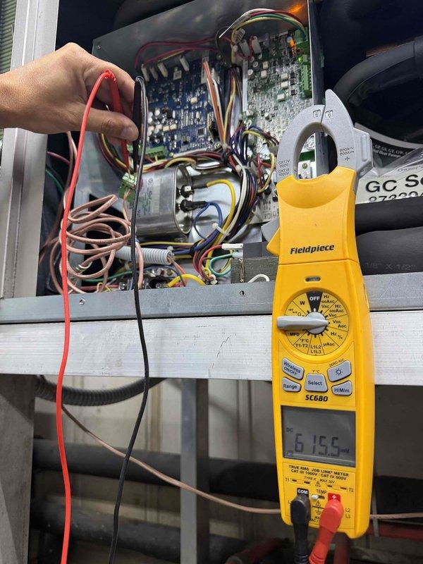 Responded to no cooling complaint on Bryant rooftop unit serving office spaces above machine shop. Upon arrival, performed diagnostic testing of electrical components and control board. Used Fieldpiece SC680 meter to measure voltage and verify proper electrical readings at control panel. Inspected circuit boards, wiring connections, and electrical components within control compartment. All measurements indicated system was operating within normal parameters at time of service call.