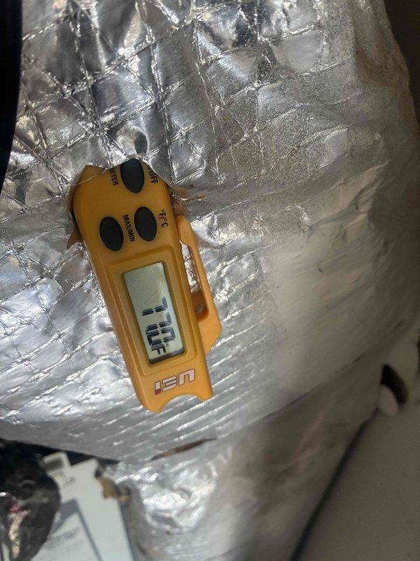 Performed cooling maintenance on HVAC system. Investigated reported water puddle near unit and inspected condensate drainage system for blockages or leaks. Took temperature and humidity readings on supply ductwork using digital instruments to verify proper system operation and diagnose potential condensation issues on insulated duct lines.