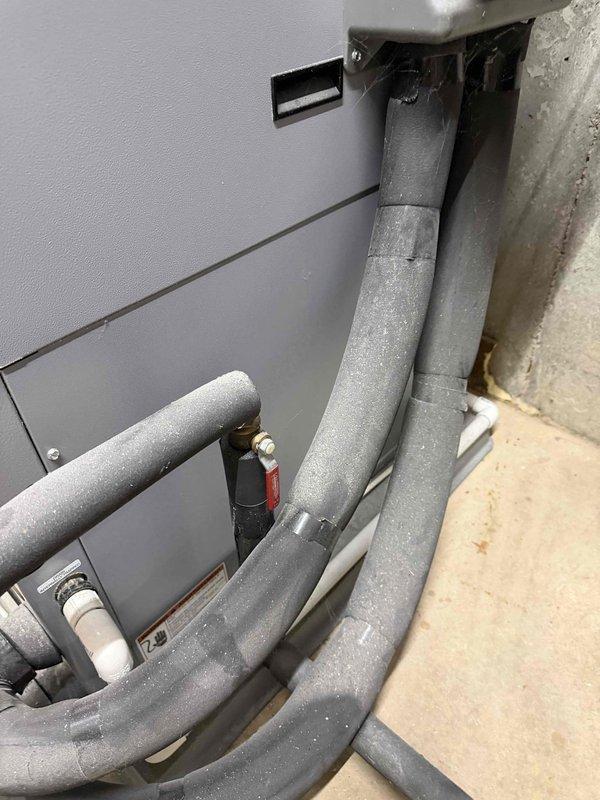 Responded to geothermal system cooling failure with SP2 error code. Attempted system reset at control panel, but error persisted despite previous successful reset earlier in the week. Inspected air handler unit and refrigerant line connections in mechanical space, documented system conditions with photos for further diagnostic evaluation and potential follow-up service to resolve recurring fault code.