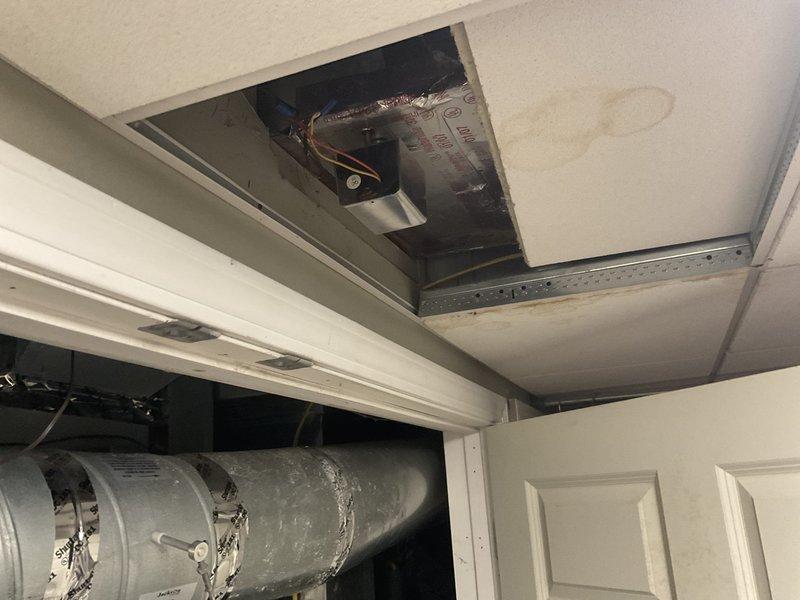 Completed on-site assessment for full HVAC system replacement at residential property. Evaluated existing air handler unit installed in interior utility space and inspected accessible ductwork components through ceiling access point. Documented current equipment configuration including Jackson HD-180R-BR unit positioning, ductwork connections, and mechanical room layout to provide comprehensive replacement estimate and system specifications.
