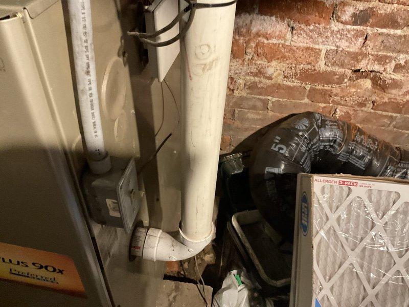 Conducted on-site evaluation of existing 15-year-old furnace system in basement utility area and provided comprehensive replacement estimate. Assessed current equipment condition, including furnace unit with PVC venting configuration, ductwork connections, and air filtration system. Documented existing installation setup with photographs showing furnace placement, associated piping, and mechanical components to support replacement recommendations previously made during prior service visit.