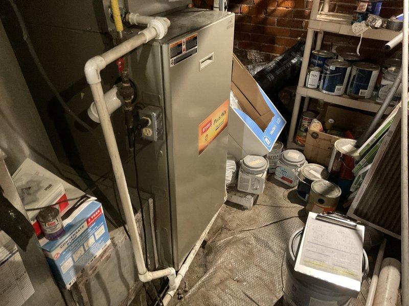 Conducted on-site evaluation of existing 15-year-old furnace system in basement utility area and provided comprehensive replacement estimate. Assessed current equipment condition, including furnace unit with PVC venting configuration, ductwork connections, and air filtration system. Documented existing installation setup with photographs showing furnace placement, associated piping, and mechanical components to support replacement recommendations previously made during prior service visit.