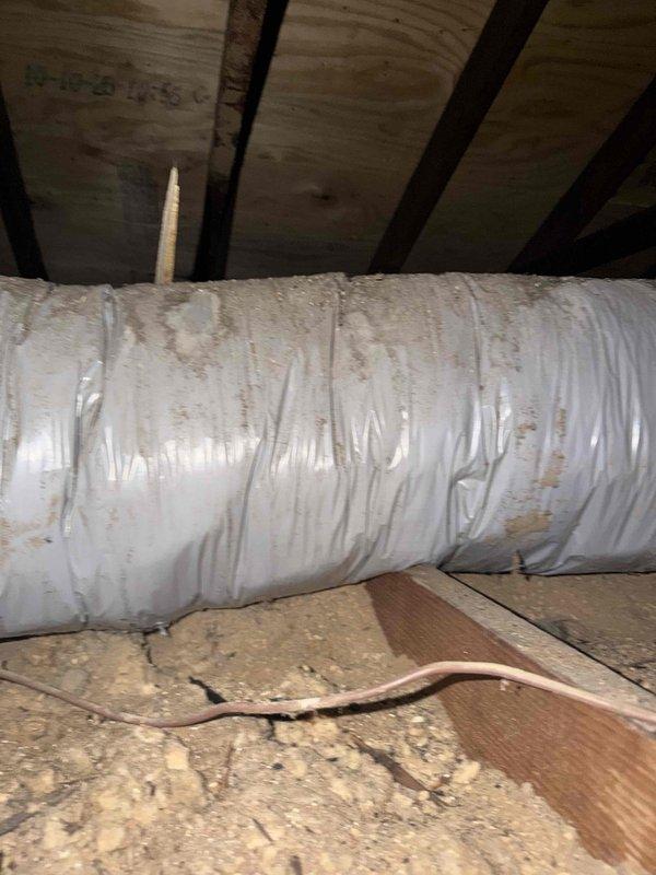 Responded to no cooling complaint at commercial property. Upon inspection, found HVAC unit installed in attic space with severely corroded support chains and mounting hardware showing extensive rust damage. Heat exchanger coil and copper refrigerant lines displayed significant age-related deterioration. Flexible ductwork in attic exhibited discoloration and aging. System components showed advanced weathering inconsistent with proper maintenance, indicating potential structural and operational concerns requiring immediate attention to restore cooling function and ensure safe operation.
