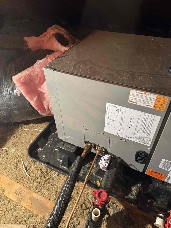 # HVAC Maintenance - Cooling System Service

Completed comprehensive first cooling maintenance service on residential HVAC system located in attic space. Performed thorough inspection of air handler unit, verified proper operation of all mechanical components, and examined refrigerant lines for signs of wear or leakage. Checked copper line connections and insulation integrity, noting existing service valve installation on refrigerant piping. Inspected electrical connections, wiring, and outlet mounting for safety compliance. Evaluated ductwork condition and insulation coverage throughout accessible areas. Verified unit mounting stability on platform and assessed surrounding insulation placement. System operating within normal parameters with no immediate repairs required. Documented equipment condition through photographic records for maintenance history. All components functioning as designed with seasonal cooling operation ready for service demand.