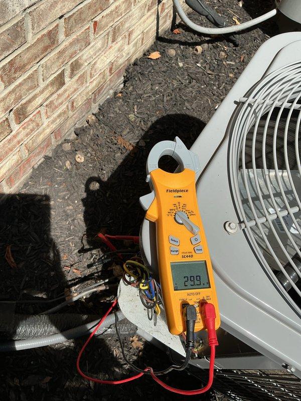 Completed scheduled cooling maintenance on residential HVAC system. Performed comprehensive diagnostic testing including voltage measurements at control board (595V reading documented) and amperage draw testing at outdoor condensing unit (2.09A recorded). Inspected internal components, electrical connections, refrigerant lines, and verified proper operation of all safety controls and status indicators. System operating within normal parameters with no deficiencies noted.