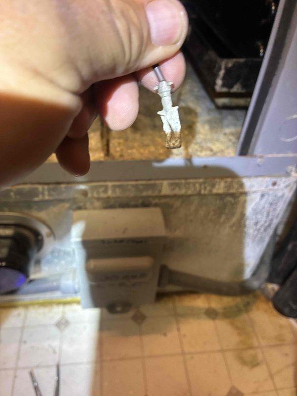 Responded to service call for geothermal system experiencing random shutdowns. Upon inspection, discovered flame sensor with damaged probe tip showing signs of corrosion and material degradation. Removed and cleaned sensor, tested system operation, and verified proper cycling without further interruptions.