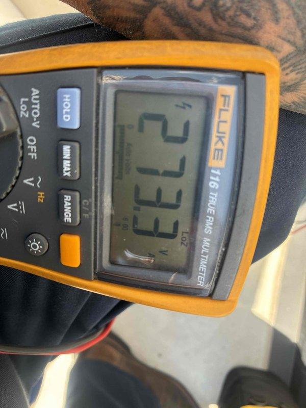Completed scheduled cooling maintenance on rooftop AC unit at townhouse location, accessing equipment via rooftop patio. Performed comprehensive system diagnostics including electrical measurements, recording 29.77 VAC and 3.333 amp readings using calibrated multimeter to verify proper voltage supply and current draw. All electrical parameters were within normal operating specifications, and unit was found to be functioning properly upon completion of maintenance inspection.