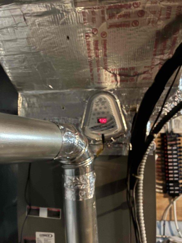Completed installation of new bypass humidifier and REME HALO air purification system on existing HVAC ductwork. Both units were properly mounted, connected to supply ductwork, and wired according to manufacturer specifications, with the REME HALO displaying operational status and the humidifier integrated into the forced air system with appropriate water supply connections.