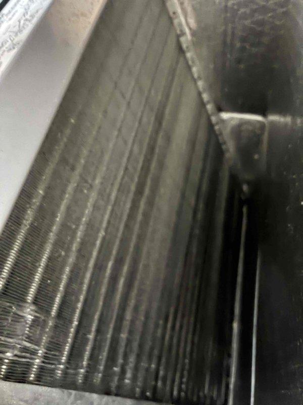 Completed scheduled cooling maintenance on HVAC system. Inspected evaporator coil and blower motor assembly, documenting existing dust and particulate accumulation on coil fins and ventilation louvers. All components found structurally intact and operational, with system functioning within normal parameters.