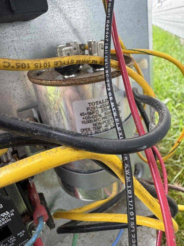 Completed scheduled cooling maintenance on outdoor condensing unit. Performed electrical diagnostics using digital clamp meter to verify system amperage and voltage levels, inspected dual-run capacitor rated at 45+5 MFD for proper operation and secure wire connections, and confirmed all electrical components functioning within manufacturer specifications.