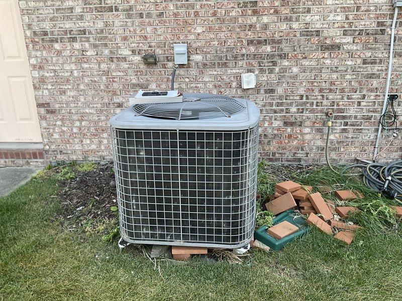 Completed residential HVAC estimate for replacement of existing heat pump system with new dual fuel heat pump system. Assessed outdoor condenser unit mounted on pad against brick exterior and indoor air handler unit located in basement utility area with existing ductwork and refrigerant line connections. Provided equipment specifications and installation recommendations for complete dual fuel system upgrade.