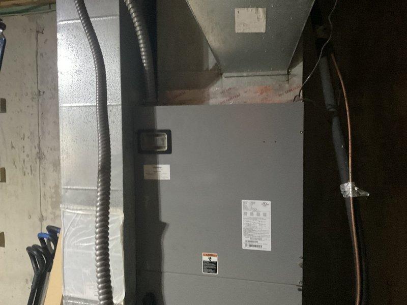 Completed residential HVAC estimate for replacement of existing heat pump system with new dual fuel heat pump system. Assessed outdoor condenser unit mounted on pad against brick exterior and indoor air handler unit located in basement utility area with existing ductwork and refrigerant line connections. Provided equipment specifications and installation recommendations for complete dual fuel system upgrade.