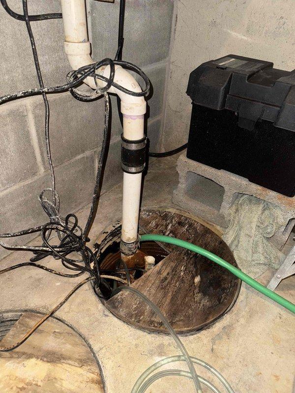# HVAC Cooling Maintenance Service Completed

Performed comprehensive cooling system maintenance inspection on residential HVAC unit. Conducted thorough visual assessment of mechanical equipment and associated utility systems in basement area. Inspected sump pump pit condition, noting significant mineral deposits and water staining consistent with normal operational wear. Verified proper drainage system functionality with PVC discharge piping and backup power supply unit in place.

Examined water heater tank and associated plumbing connections, including brass compression fittings and shut-off valves. Confirmed all mechanical components were properly secured and accessible for future service needs. Documented equipment conditions through photographic records for maintenance history files. All utility systems found operational with no immediate service requirements identified during this scheduled maintenance visit.
