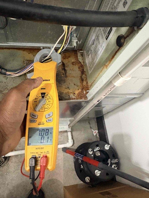 Completed commercial cooling system tune-up and preventative maintenance on rooftop-mounted air conditioning unit. Performed electrical diagnostics using digital multimeter to verify proper voltage and amperage readings at system components, inspected condenser unit exterior condition, checked fan operation and guard assembly, and evaluated overall system performance. Unit found to be operating within normal parameters with no immediate repairs required.