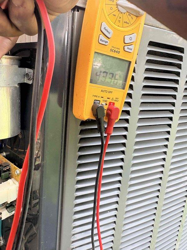 Completed scheduled cooling maintenance on Trane system. Performed comprehensive system diagnostics including electrical testing with digital multimeter, verified proper voltage readings at components, and inspected condenser unit operation. Confirmed thermostat functionality with display showing accurate temperature reading of 73°F and cooling setpoint of 69°F in active cooling mode. All electrical connections tested secure, refrigerant pressures within manufacturer specifications, and system operating efficiently with no deficiencies noted.