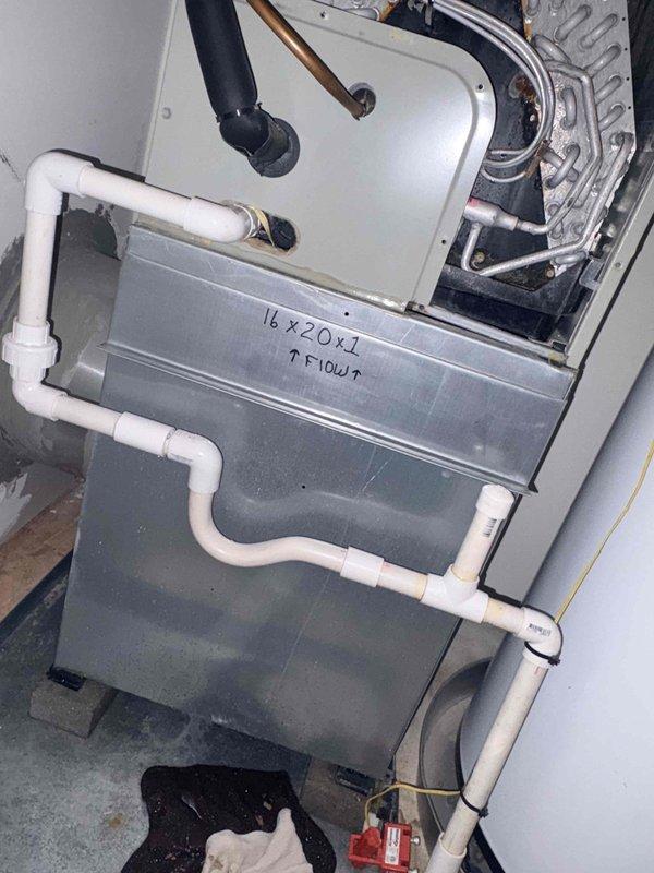 Responded to service call for furnace leaking issue. Inspected air handler unit and condensate drain system, including PVC drain line configuration and trap assembly. Cleared clogged condensate drain line to restore proper drainage and prevent water leakage from HVAC system.