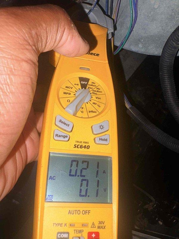 Completed comprehensive tune-up on residential cooling system. Inspected air filter showing significant dust accumulation and discoloration in pleated media, indicating proper filtration but need for replacement. Performed electrical diagnostics using digital multimeter, recording amperage draw of 0.21A and voltage reading of 0.1V AC to verify system performance and component operation within manufacturer specifications.