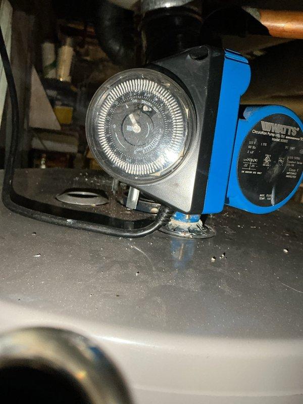 Performed diagnostic evaluation of non-functioning hot water circulator system. Inspected Watts brand circulation pump with integrated mechanical timer control, documenting equipment condition and configuration through photographs. Identified circulation pump with timer mechanism requiring further assessment, with HVAC technician scheduled to complete additional maintenance procedures.
