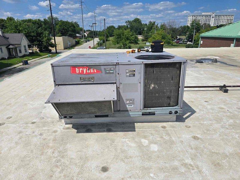 Responded to no cooling complaint on Bryant rooftop package unit. Upon arrival, inspected refrigerant lines and found severely oxidized copper tubing with significant discoloration indicating moisture exposure and possible previous leak history. Observed deteriorated coil condition in confined mechanical space with evidence of environmental damage to piping system. Documented equipment condition with photos showing compromised refrigerant lines and aged components requiring attention to restore proper cooling operation.