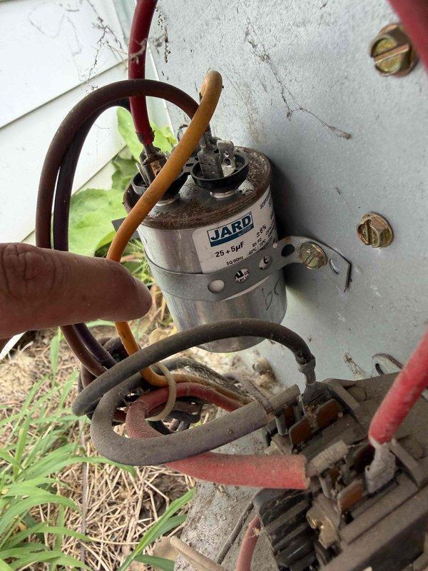 Responded to no cooling call with reported buzzing noise from outdoor unit. Upon arrival, performed diagnostic evaluation of air conditioning system. Inspected electrical components and tested dual-run capacitor using digital multimeter. Found capacitor failed and unable to hold proper charge, preventing compressor and condenser fan motor from starting. Buzzing noise confirmed as compressor attempting to start with insufficient capacitance. Replaced failed capacitor with new dual-run capacitor rated at 25+5 microfarads. Verified proper electrical connections to compressor and fan motor terminals. Cycled system on and tested operation. Compressor and condenser fan motor started successfully without abnormal noise. Confirmed adequate cooling performance and proper amp draw on both motors. System restored to normal operation.