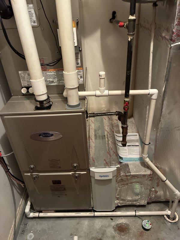 Completed warranty callback to address installation deficiencies on Carrier HVAC system. Rebuilt condensate drain line with new PVC piping and fittings to ensure proper drainage from drain pan, installed float switch safety device in drain pan to prevent overflow conditions, applied insulation to exposed refrigerant line set, and completed perimeter caulking around penetrations and system components to seal installation properly.
