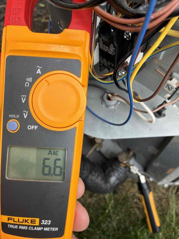 Completed routine cooling maintenance visit on HVAC system. Performed electrical diagnostics using clamp meter, recording amperage readings of 66 AAC and 0.7 AAC on system components to verify proper electrical operation and compressor performance. Inspected outdoor condensing unit wiring, capacitor, and electrical connections; all components found to be functioning within normal parameters and system operating efficiently.