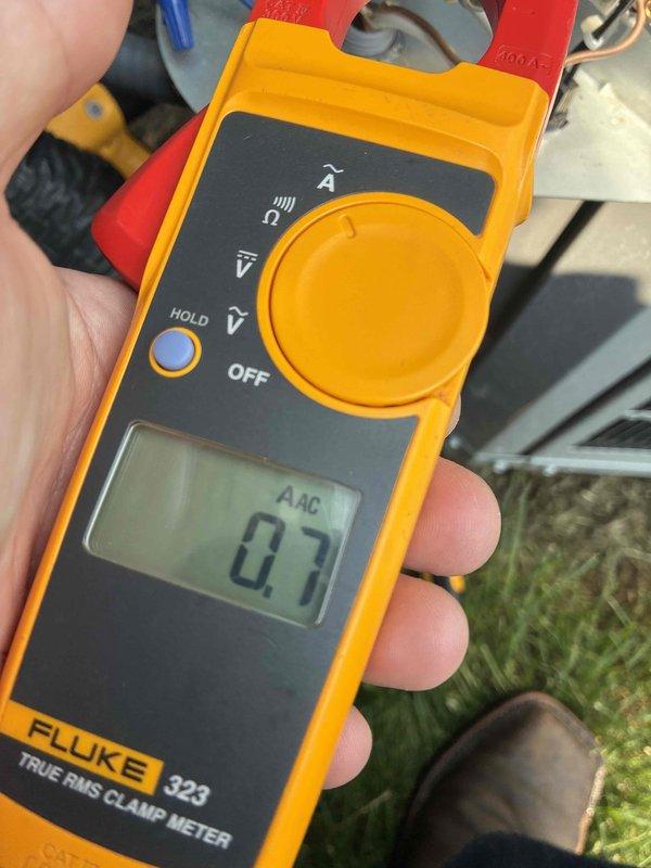 Completed routine cooling maintenance visit on HVAC system. Performed electrical diagnostics using clamp meter, recording amperage readings of 66 AAC and 0.7 AAC on system components to verify proper electrical operation and compressor performance. Inspected outdoor condensing unit wiring, capacitor, and electrical connections; all components found to be functioning within normal parameters and system operating efficiently.