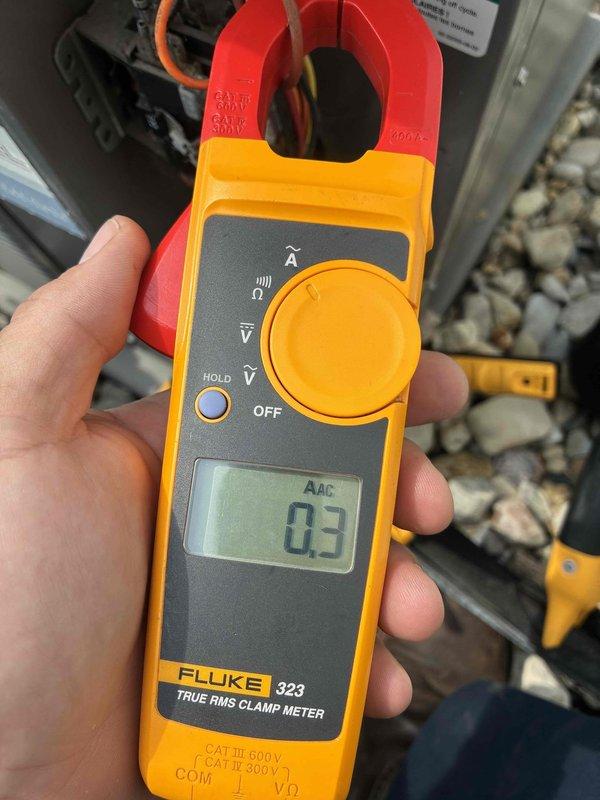 Completed routine cooling system maintenance on residential HVAC unit. Performed electrical diagnostics using clamp meter, measuring compressor amperage draw at 4.8 amps on the outdoor condensing unit, which falls within normal operating parameters. Verified proper electrical current flow and system operation during inspection.