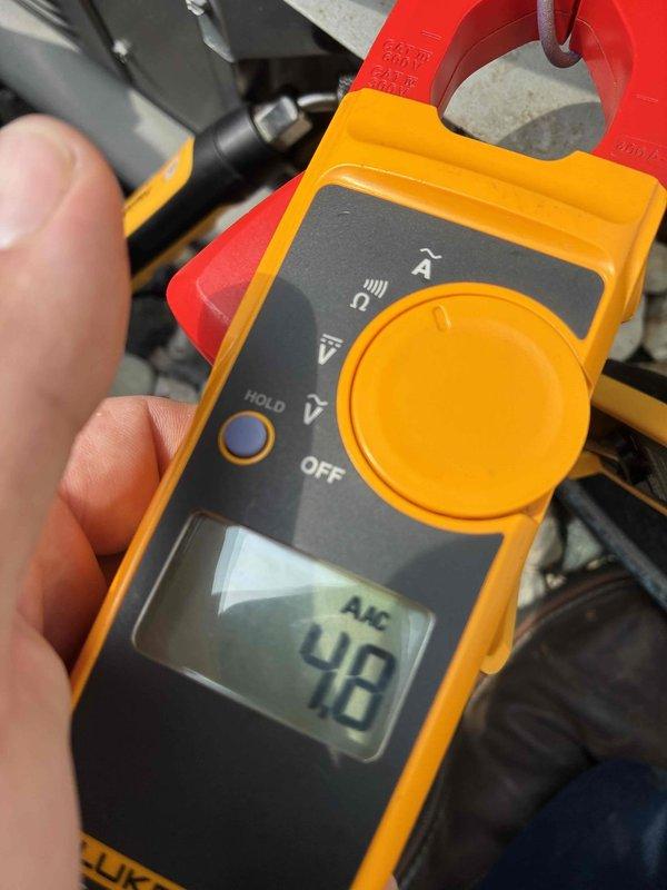 Completed routine cooling system maintenance on residential HVAC unit. Performed electrical diagnostics using clamp meter, measuring compressor amperage draw at 4.8 amps on the outdoor condensing unit, which falls within normal operating parameters. Verified proper electrical current flow and system operation during inspection.
