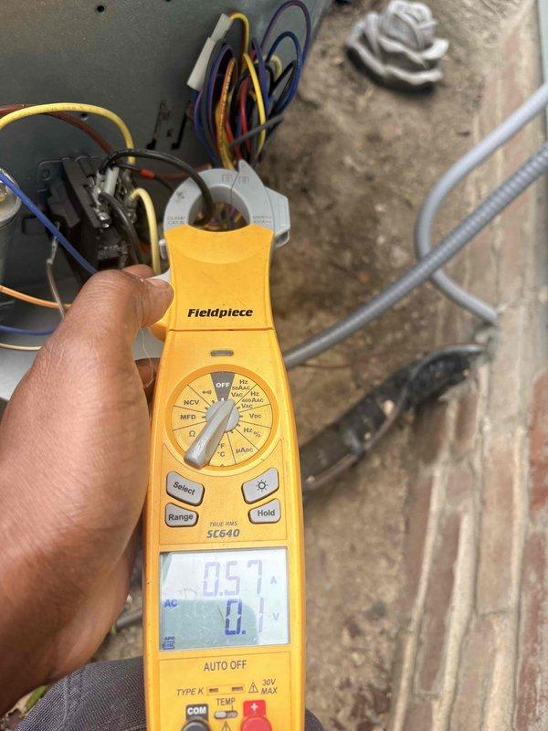 Completed scheduled cooling maintenance on residential air conditioning system. Performed electrical diagnostics using digital multimeter, measuring voltage and capacitance at contactor and control circuit connections, with readings indicating normal operating parameters at 300.0 VAC and 0.57 microfarads. Inspected outdoor condensing unit, verified proper electrical connections, and confirmed system operational status.