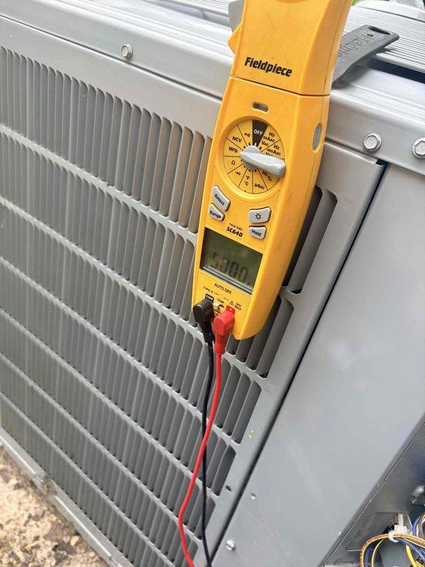 Completed scheduled cooling maintenance on residential air conditioning system. Performed electrical diagnostics using digital multimeter, measuring voltage and capacitance at contactor and control circuit connections, with readings indicating normal operating parameters at 300.0 VAC and 0.57 microfarads. Inspected outdoor condensing unit, verified proper electrical connections, and confirmed system operational status.