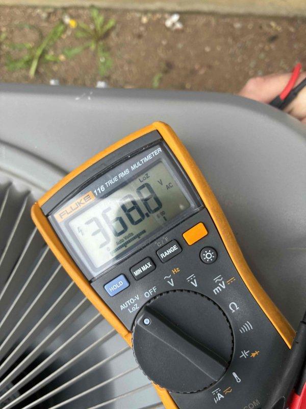 Completed scheduled cooling system maintenance visit on outdoor HVAC condenser unit. Performed standard diagnostic testing including voltage measurements at 97.8V AC using digital multimeter and amperage readings at 6.6A using clamp meter on refrigerant lines. Unit operational with all electrical parameters within normal operating range.