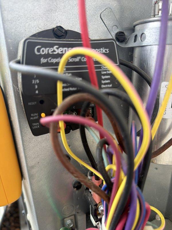 Completed scheduled cooling maintenance on HVAC system equipped with Copeland Scroll compressor and CoreSense Diagnostics control panel. Performed standard system inspection, verified all control panel indicators functioning properly including RUN/ALERT status lights, checked electrical connections and color-coded diagnostic wiring, and confirmed capacitor operation within normal parameters.
